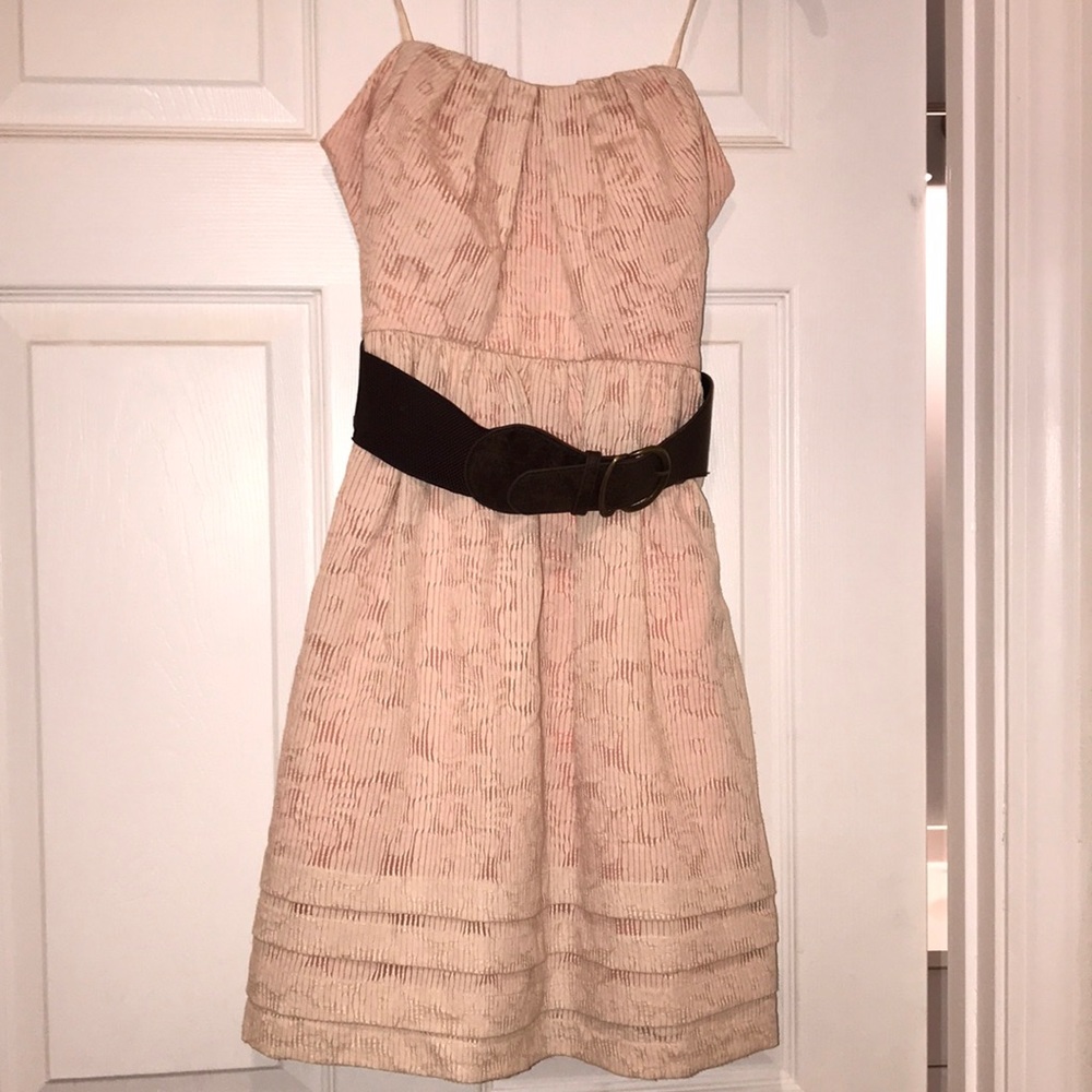 Peach strapless dress with a brown belt